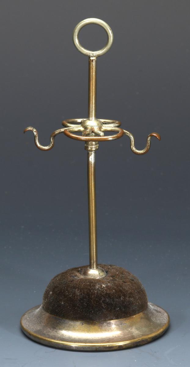 AN ANTIQUE SILVER PLATED HAT PIN STAND