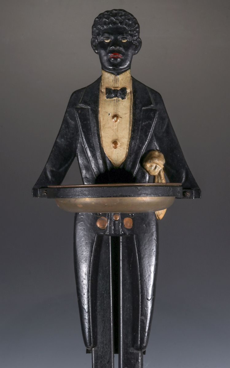 A GREAT ART DECO TUXEDOED BUTLER CAST IRON STAND