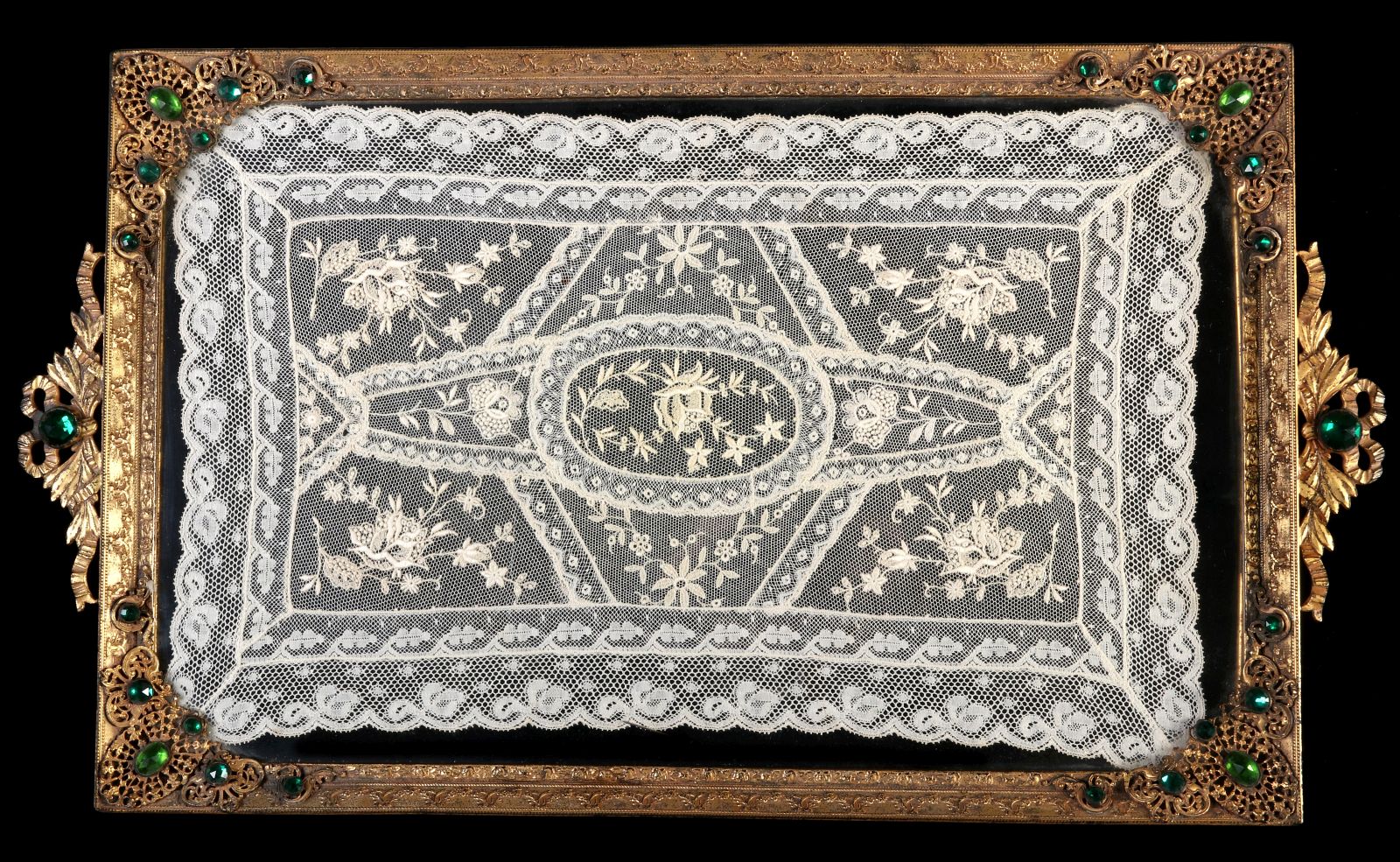 AN ANTIQUE JEWELED BRASS TRAY WITH LACE