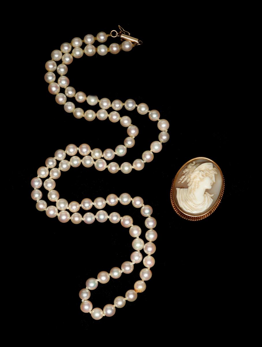 A MATINEE-LENGTH PEARL STRAND AND CAMEO BROOCH
