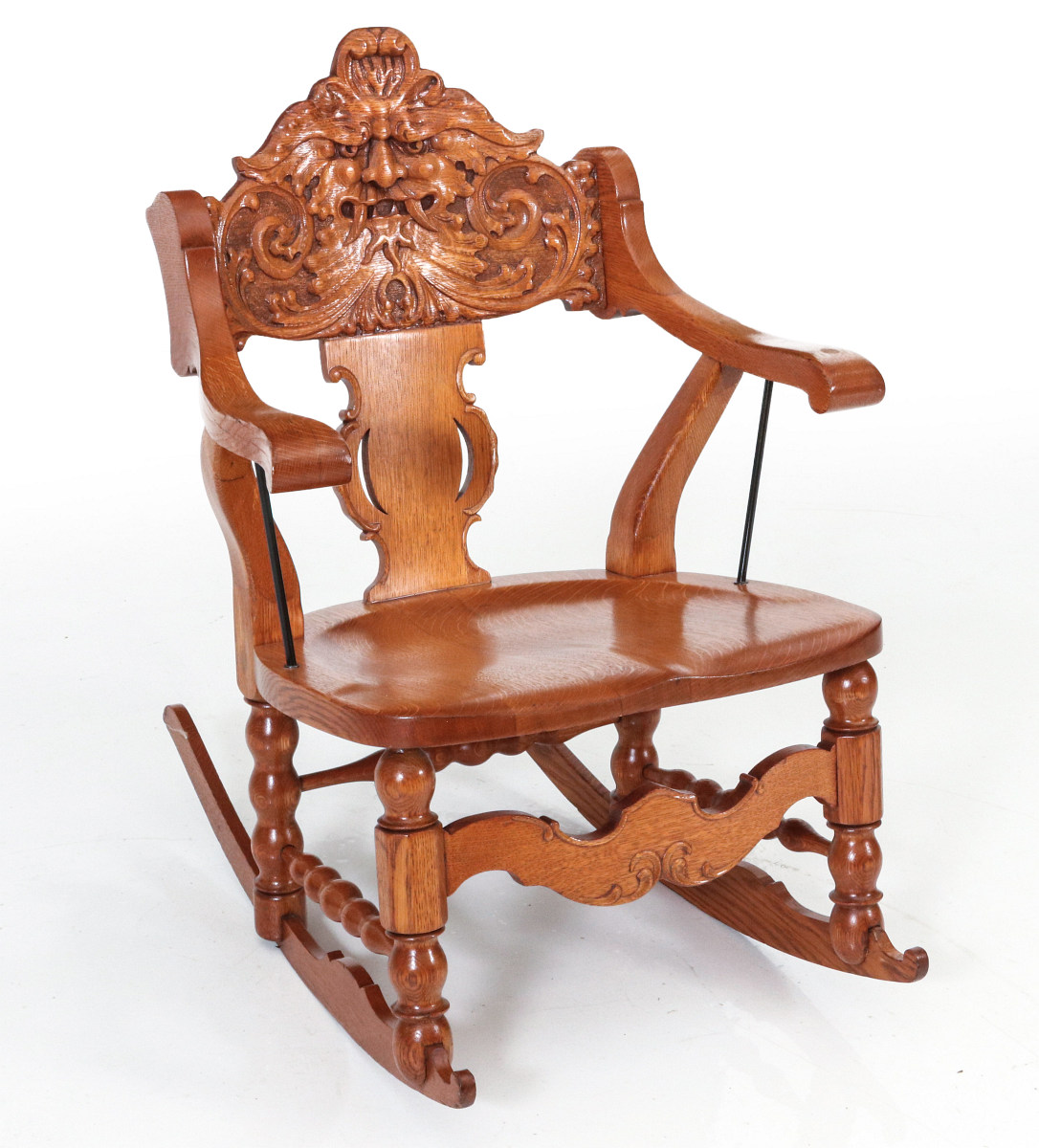 A HEAVILY CARVED LATE 19TH C. AMERICAN ROCKING CHAIR