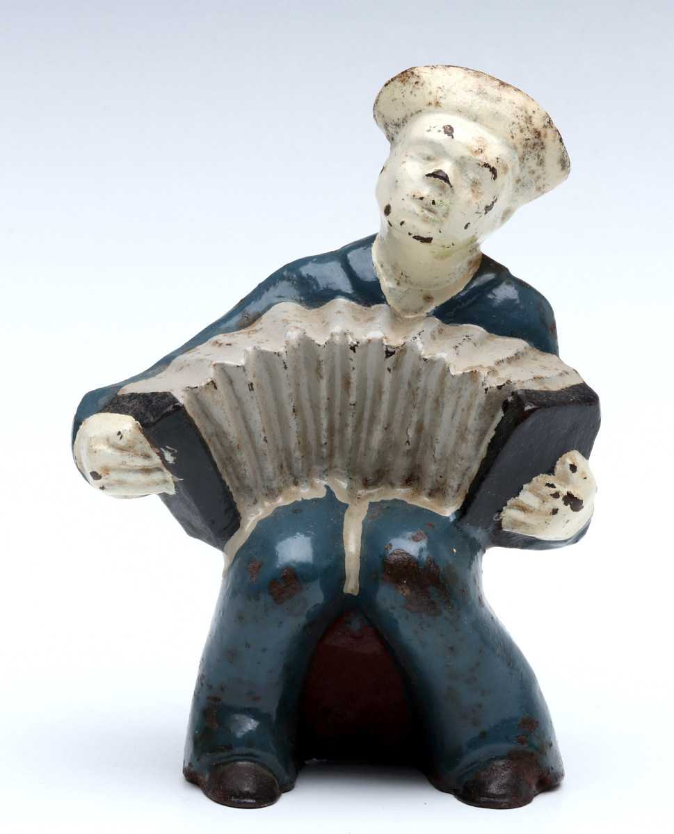 A HUBLEY SAILOR W/ ACCORDION CAST IRON BOOKEND