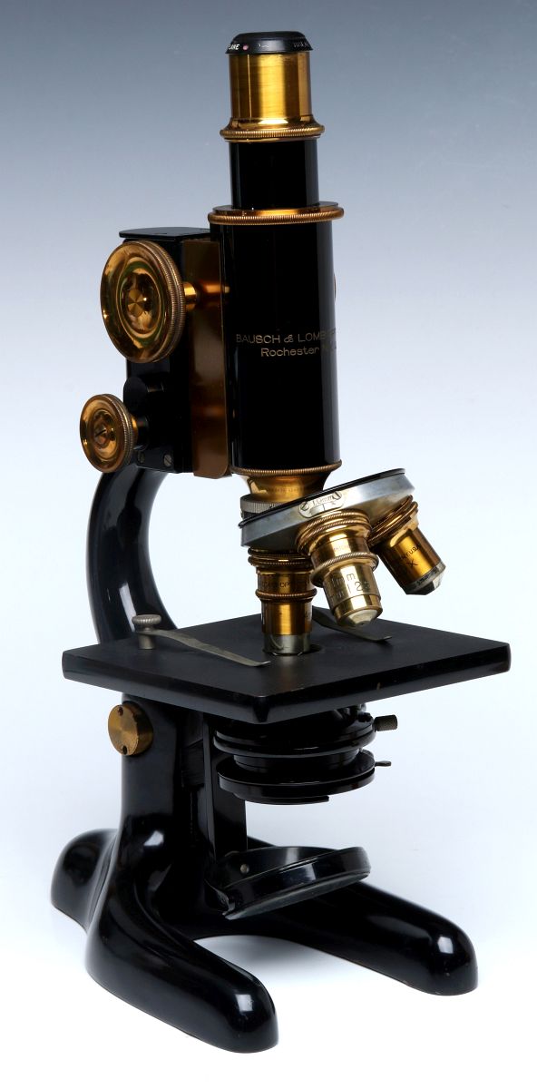 A BAUSCH AND LOMB HORSE SHOE BASE MICROSCOPE