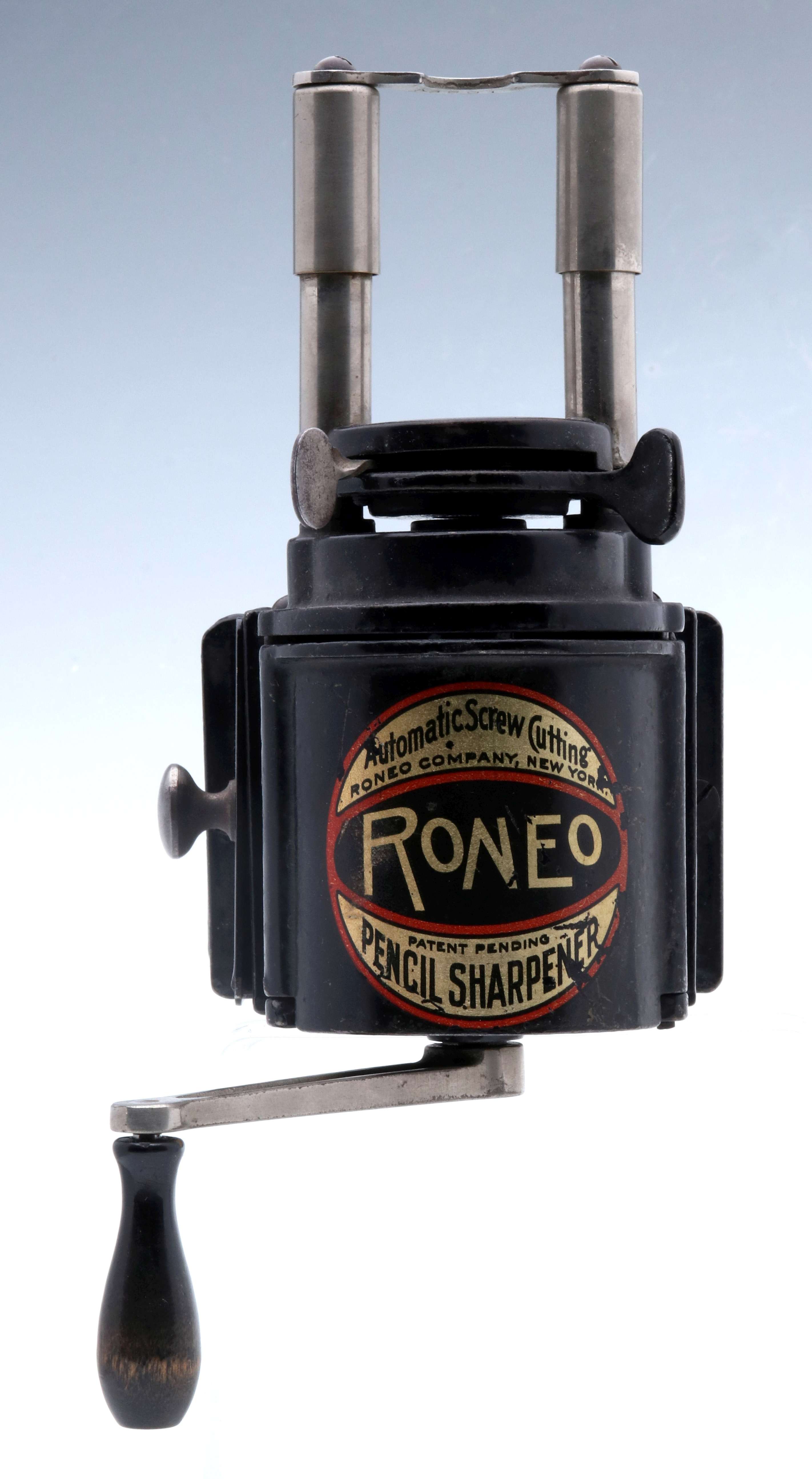 A RONEO CAST IRON PENCIL SHARPENER DATED 1913