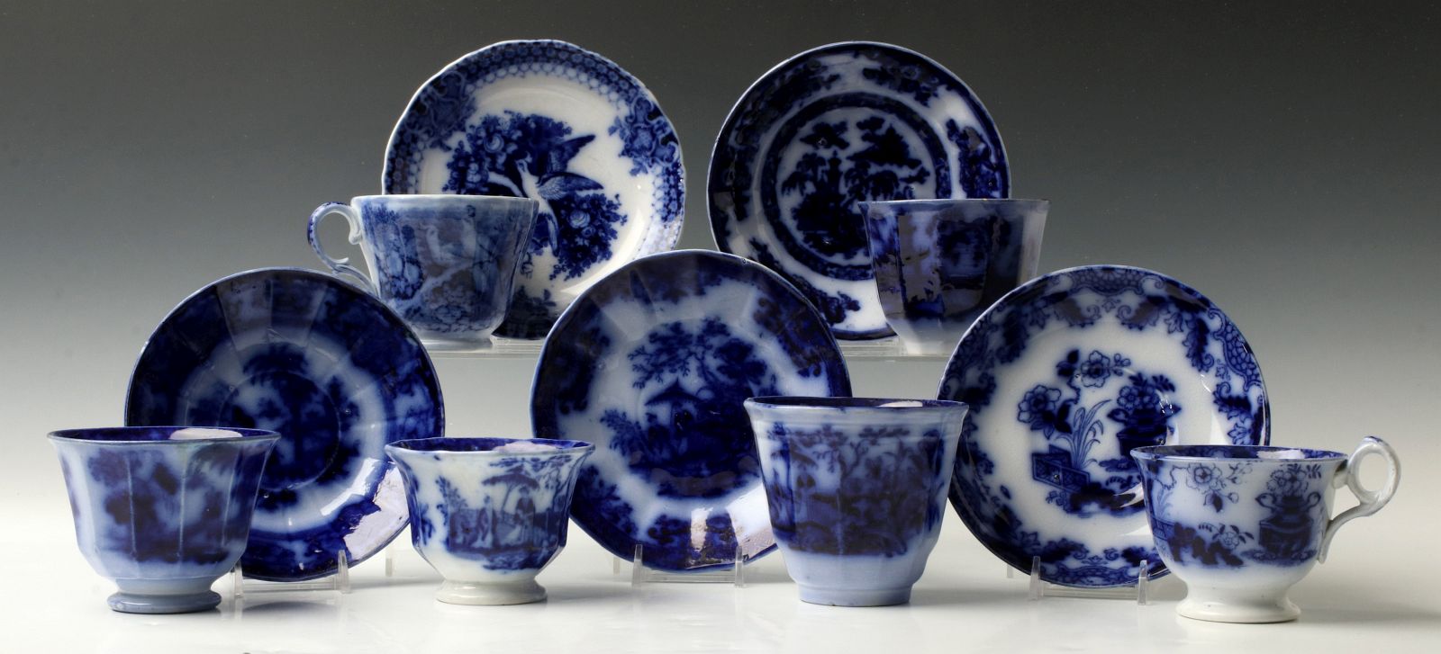 A GOOD COLLECTION OF FLOW BLUE CUPS AND SAUCERS