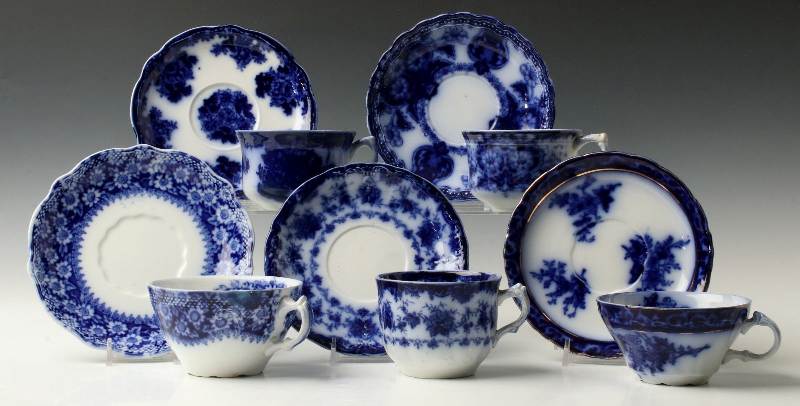 A NICE COLLECTION OF FLOW BLUE CUPS AND SAUCERS