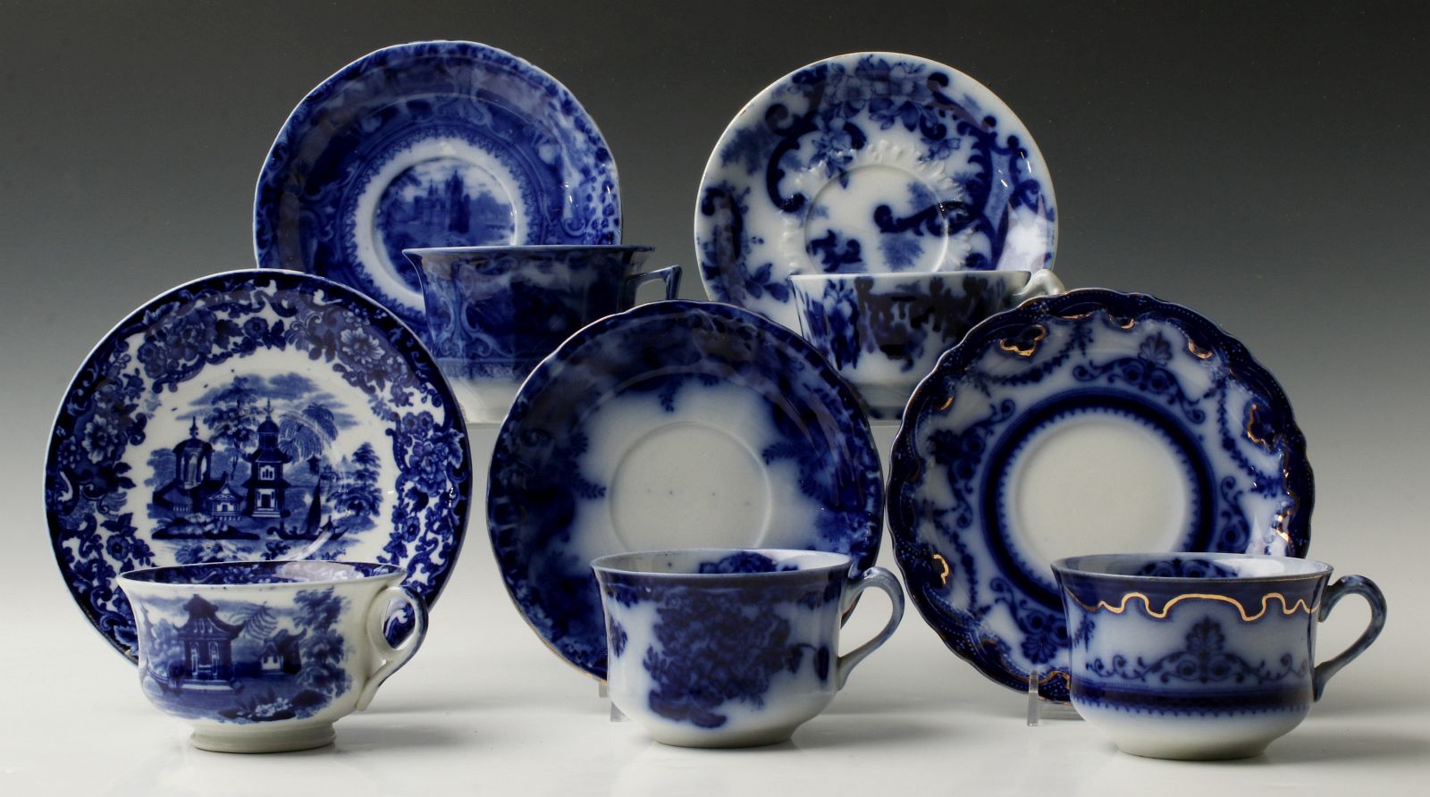 A COLLECTION OF VARIOUS FLOW BLUE CUPS AND SAUCERS