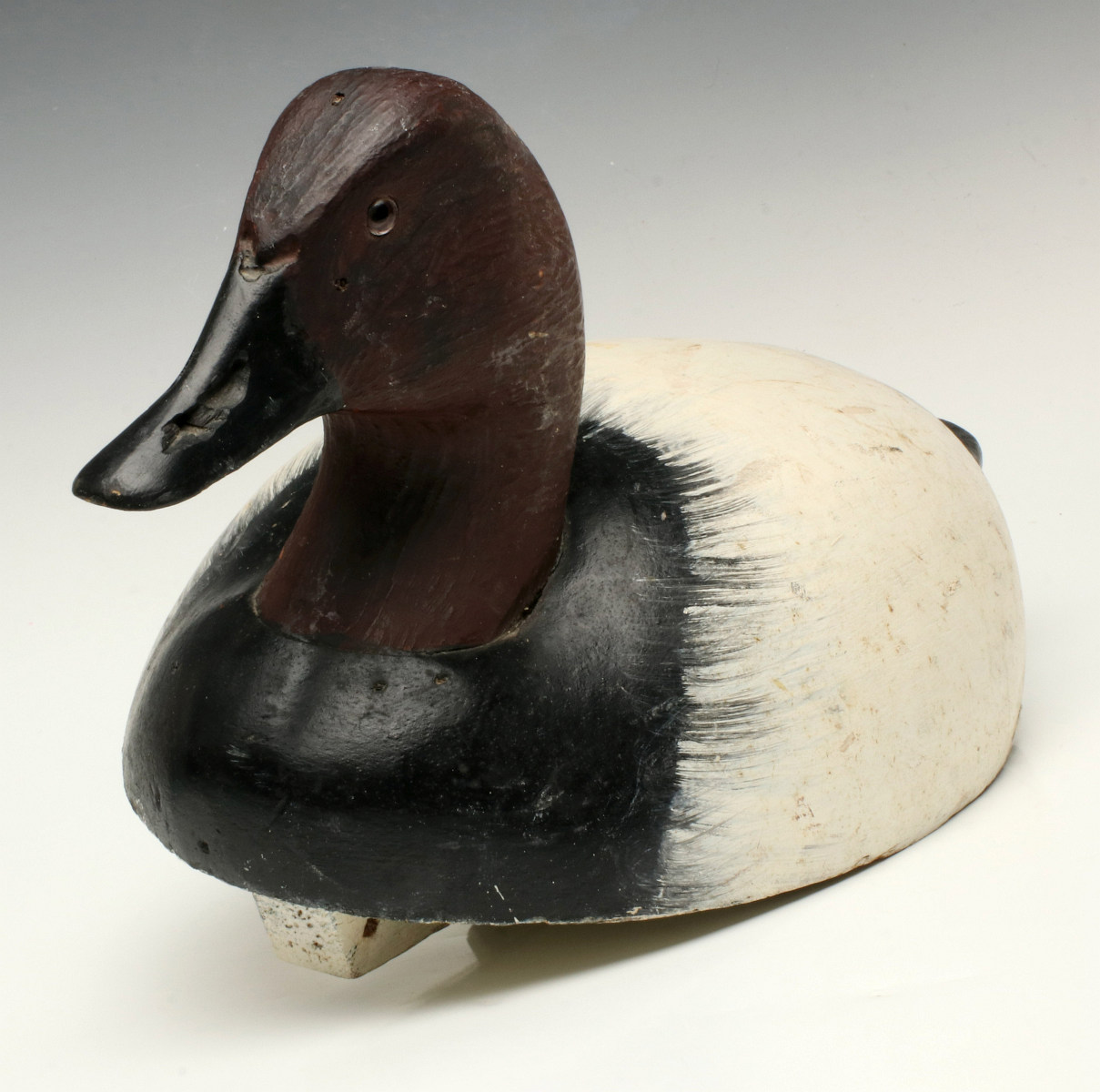 A CARVED AND PAINTED CANVASBACK DRAKE DECOY