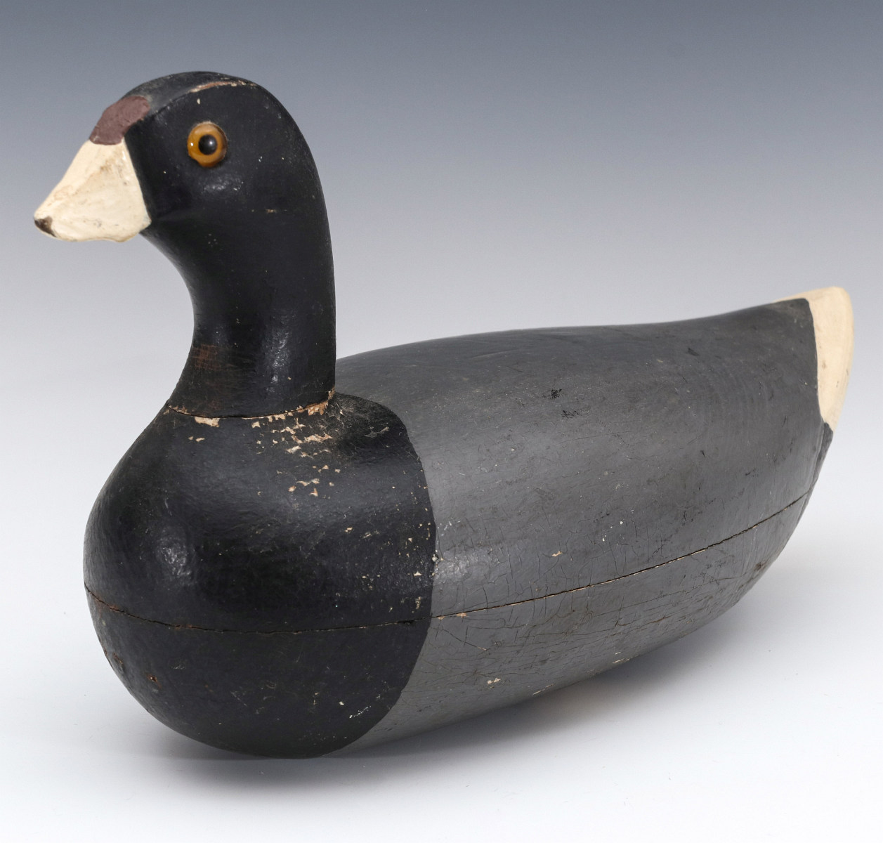 A PRIMITIVE UNSIGNED CARVED PAINTED WOOD COOT DECOY