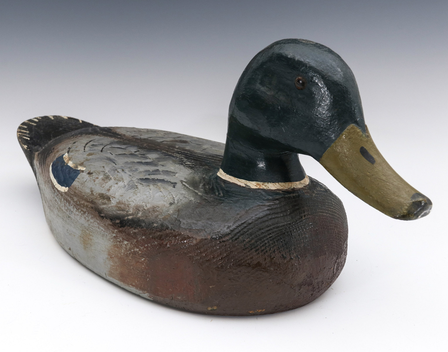 AN ANTIQUE CARVED AND PAINTED MALLARD DRAKE DECOY