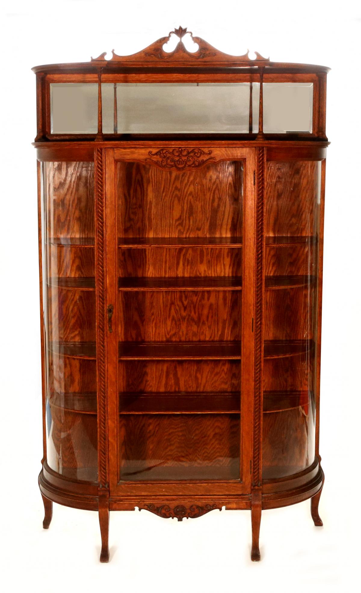 A CURVED OAK CHINA CABINET WITH MIRRORED UPPER