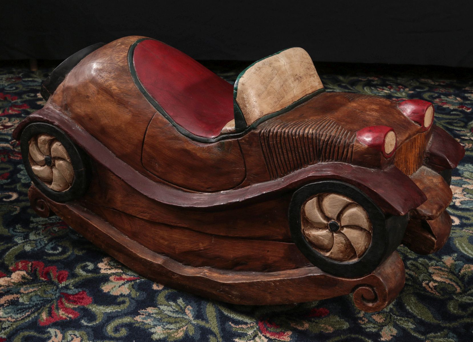 A CARVED AND PAINTED CHILD'S ROCKING RIDE-ON TOY
