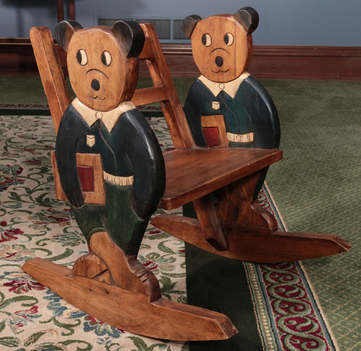 A CARVED AND PAINTED CHILD'S ROCKING CHAIR