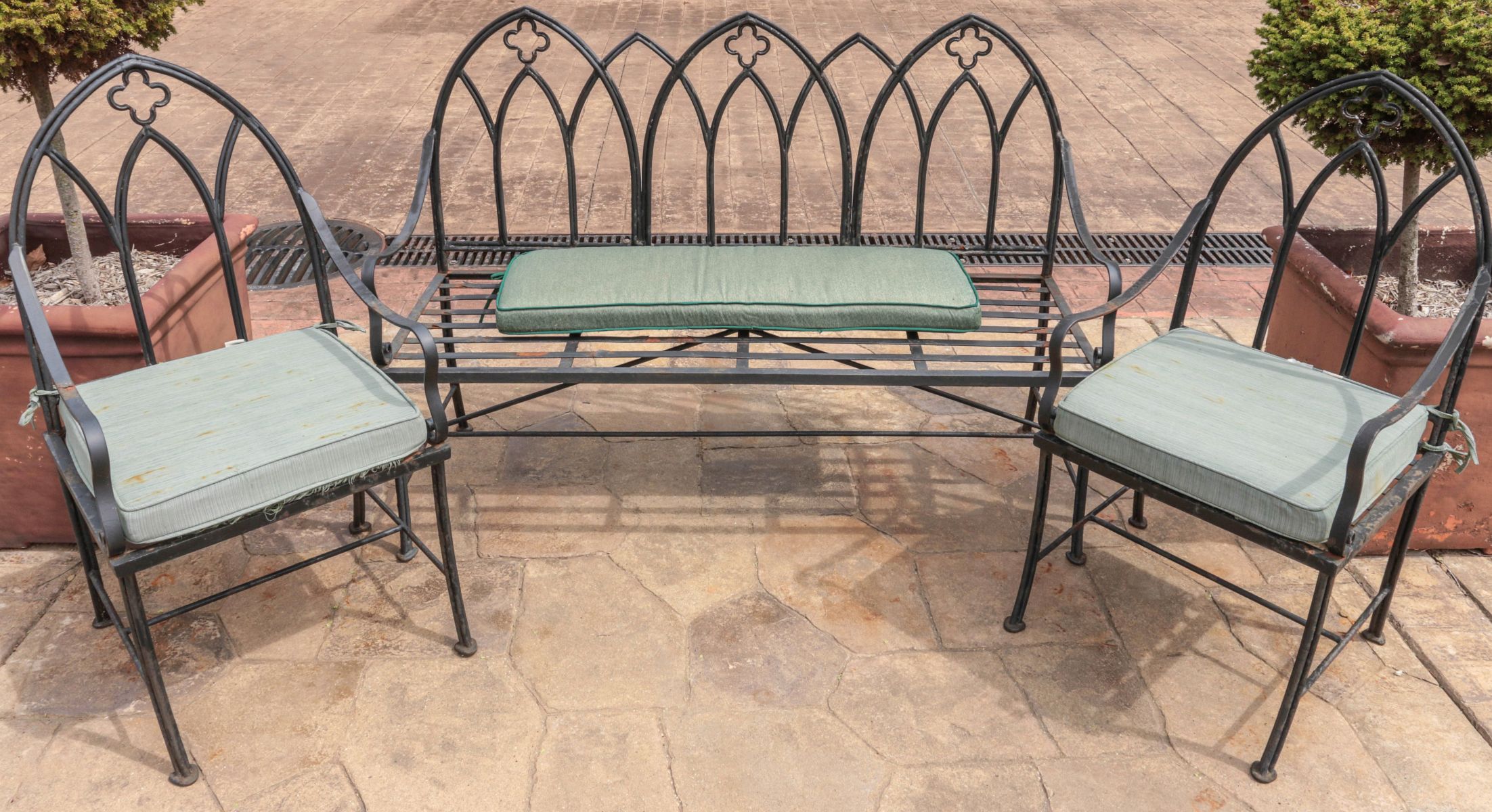A THREE PIECE IRON PATIO SET WITH GOTHIC ARCH BACK