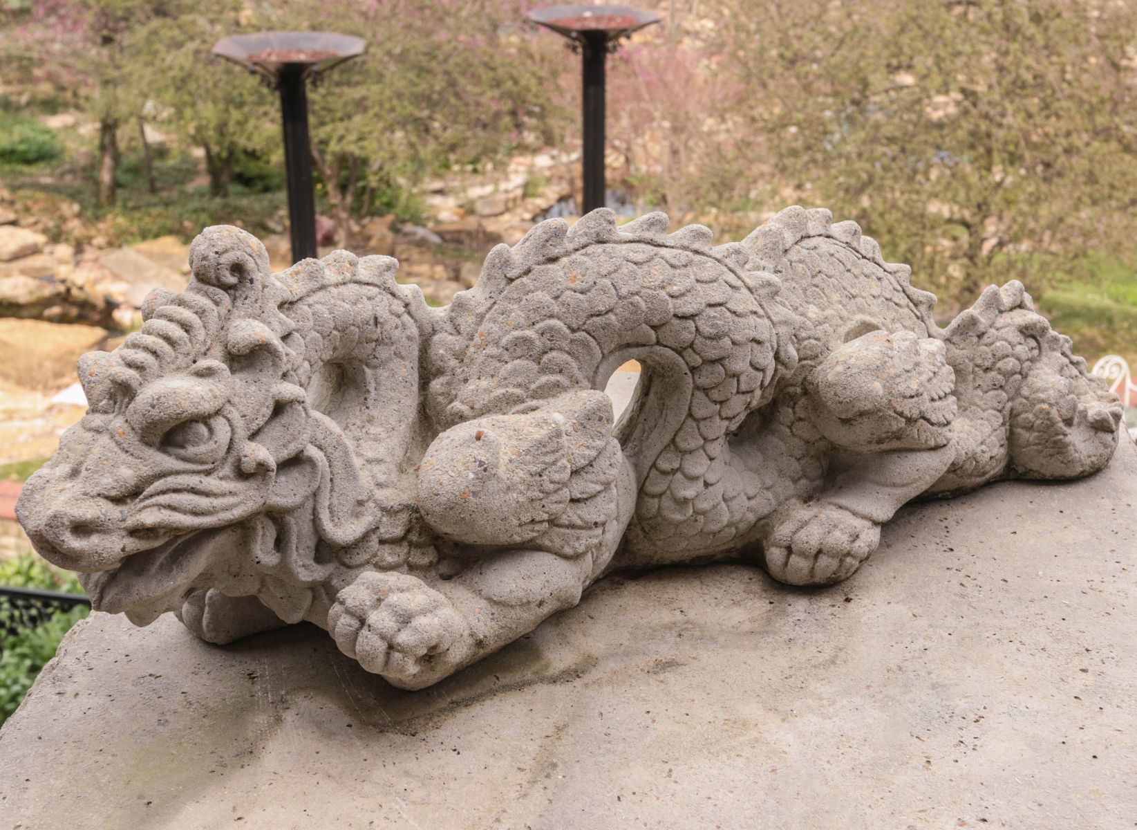 A CAST CONCRETE FIGURE OF A DRAGON