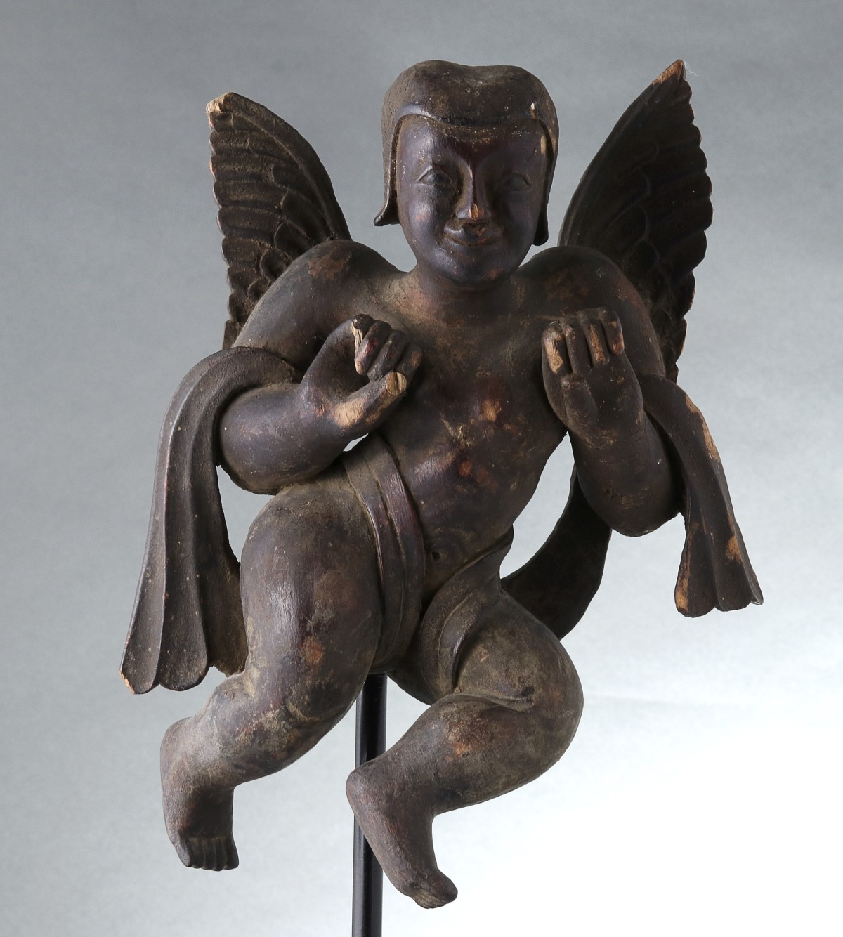 A PRIMITIVE WOOD CARVING OF AN ANGEL