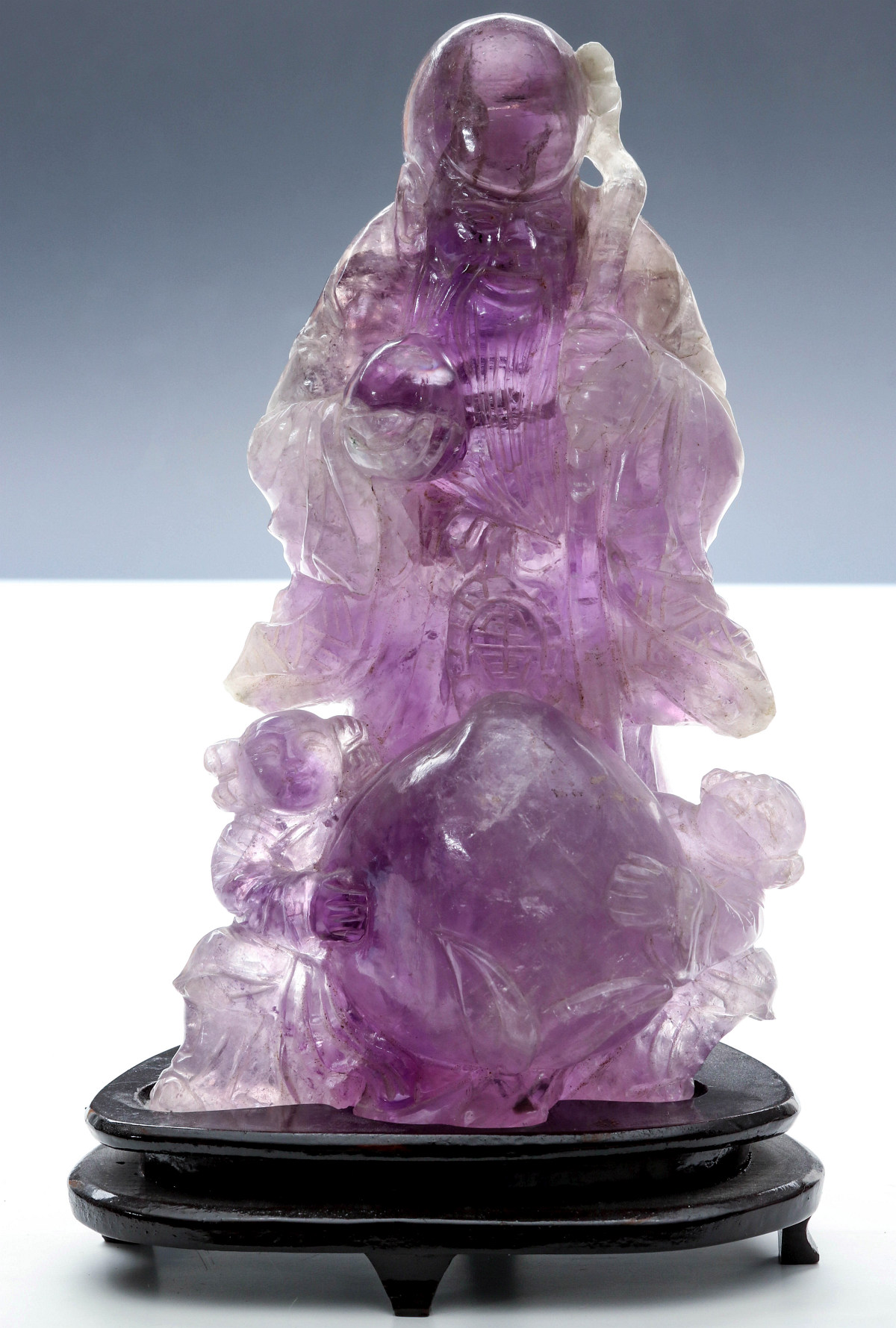 AN ASIAN AMETHYST HARDSTONE CARVING OF SCHOLAR