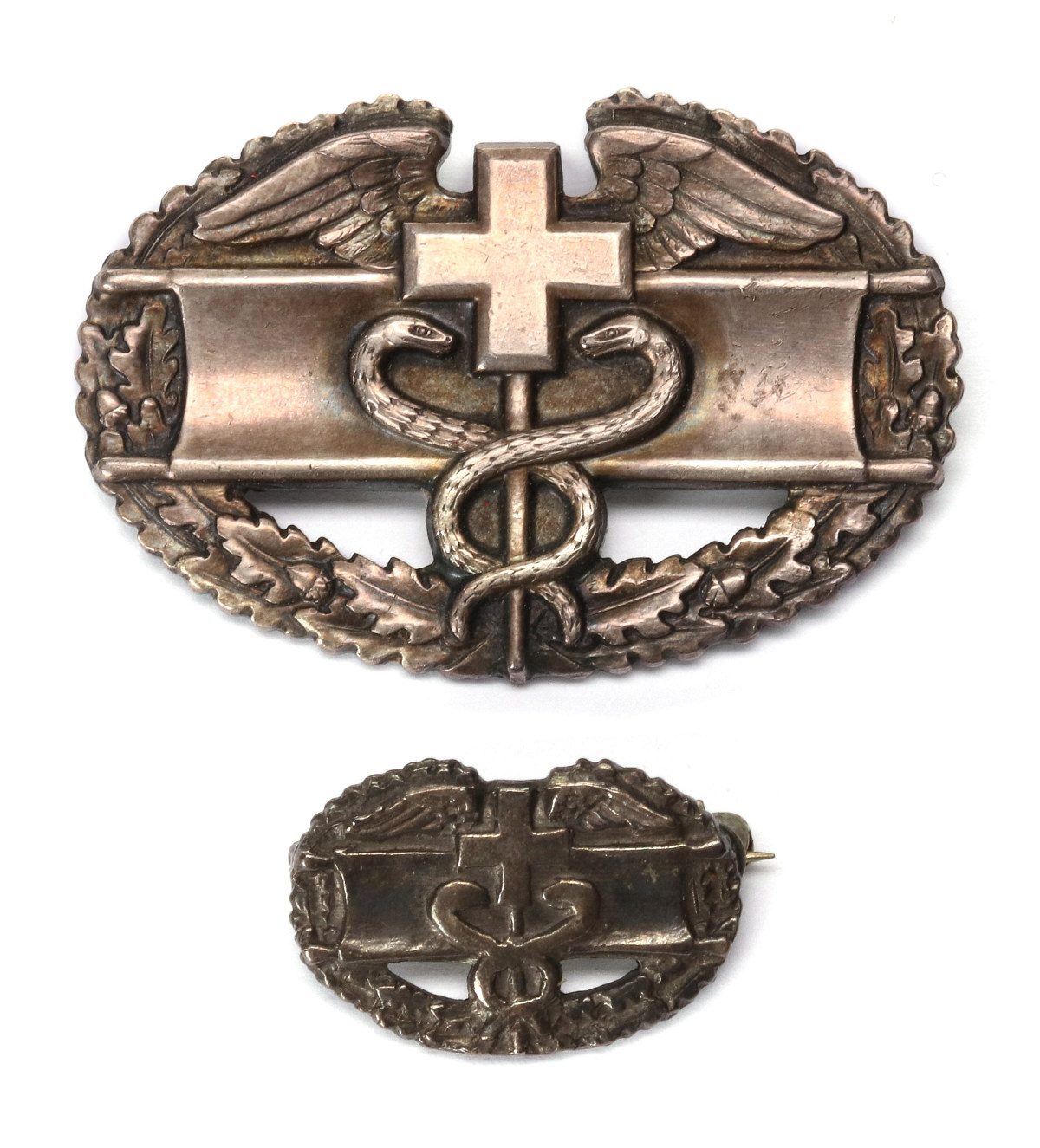 TWO DIFFERENT STERLING SILVER COMBAT MEDIC BADGES