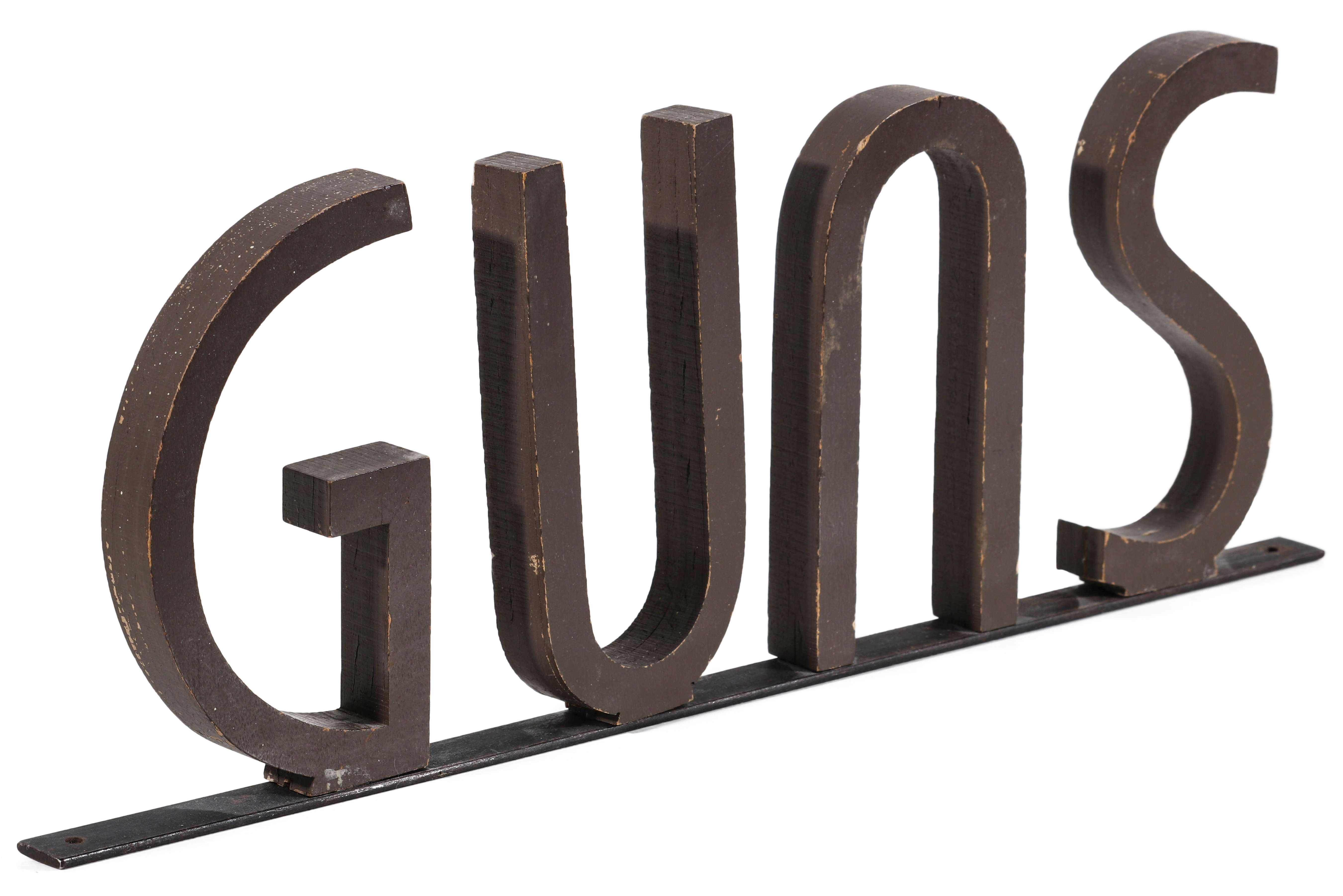 A CIRCA 1930s PAINTED WOOD LETTER GUNS SIGN
