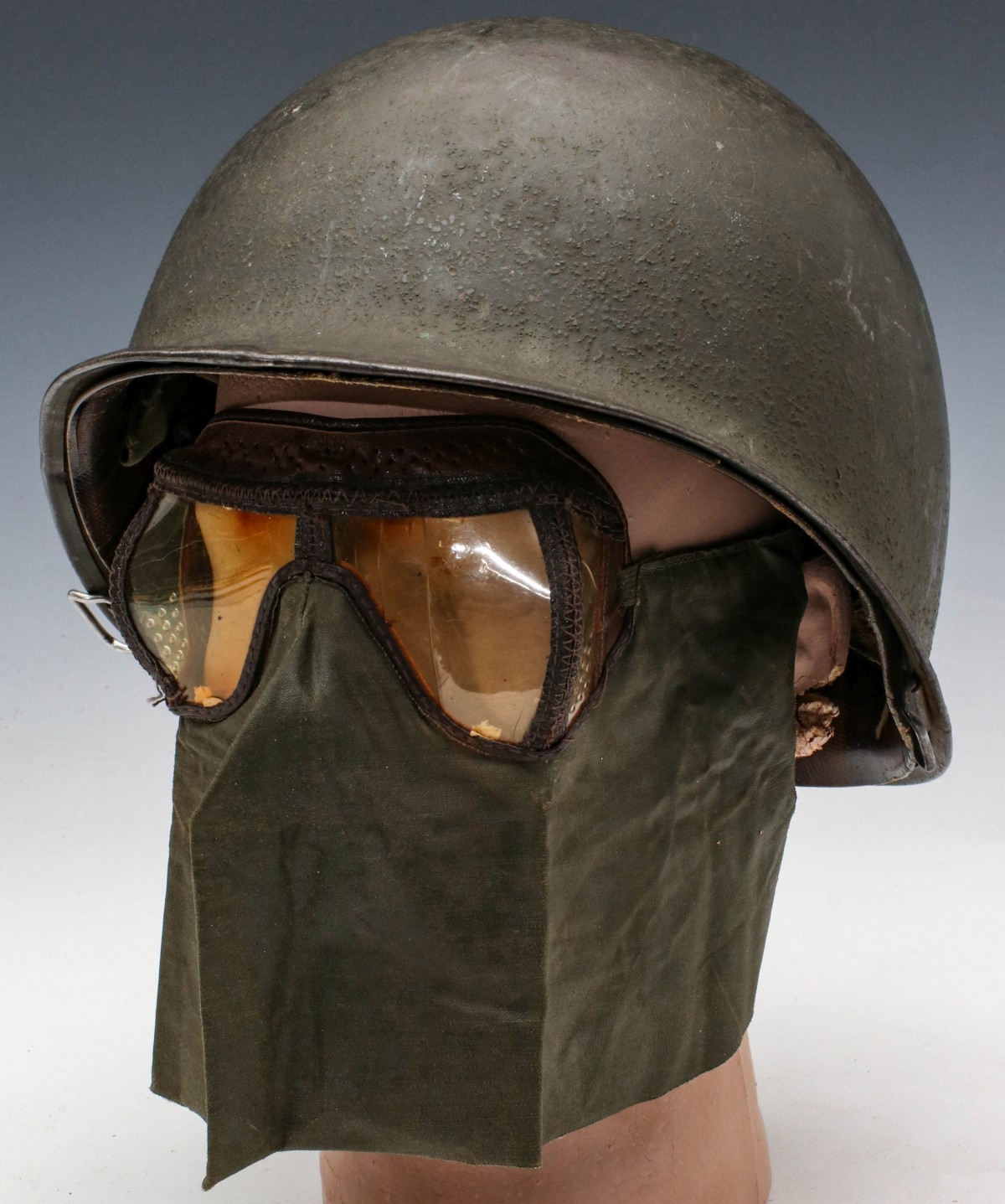 A WWII BALE HELMET WITH FACE MASK