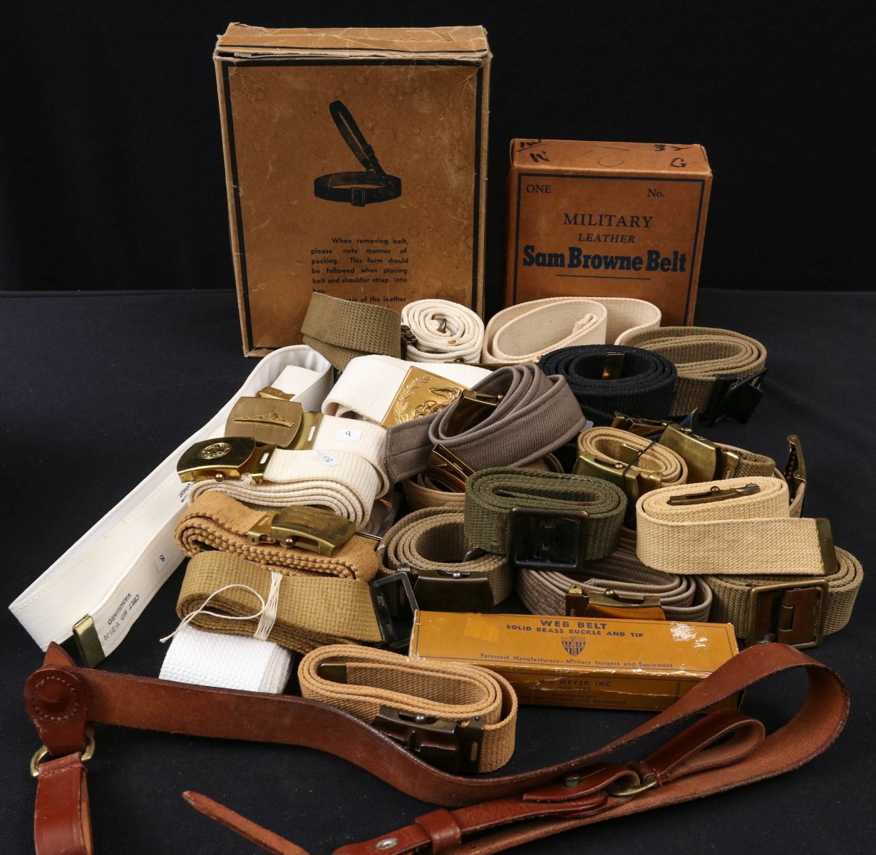 A LARGE COLLECTION OF WWII SAM BROWNE AND OTHER BELTS