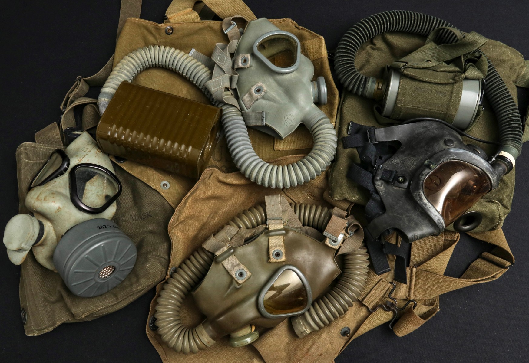 A COLLECTION OF VARIOUS US WWII GAS MASKS