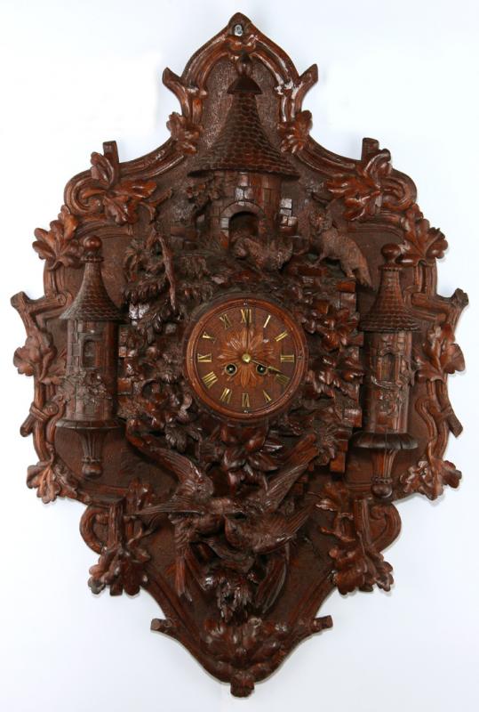 A HIGHLY CARVED BLACK FOREST CASTLE WALL CLOCK 