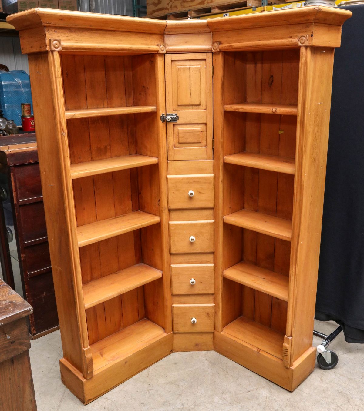 AN INTERESTING PINE CORNER DISPLAY CABINET WITH DRAWERS