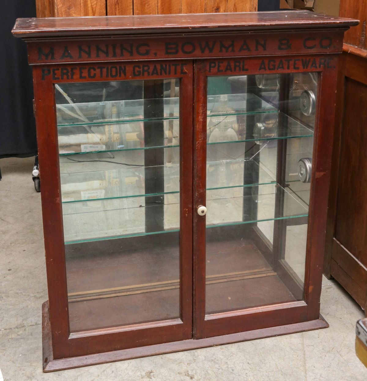 AN ANTIQUE CABINET TOP WITH LETTERING ADDED