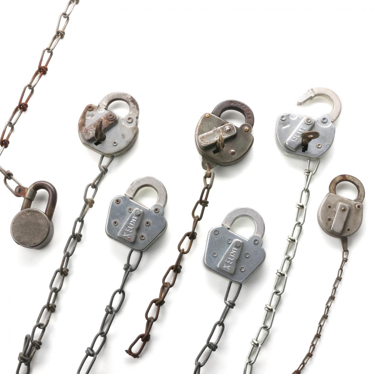 SEVEN PADLOCKS WITH STAMPED MARKINGS OF THREE RAILROADS