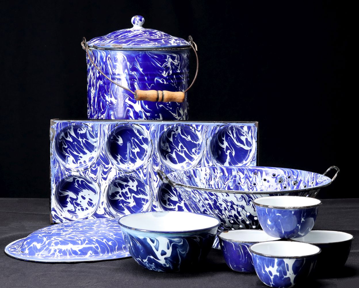 A COLLECTION OF ANTIQUE BLUE SWIRL GRANITEWARE