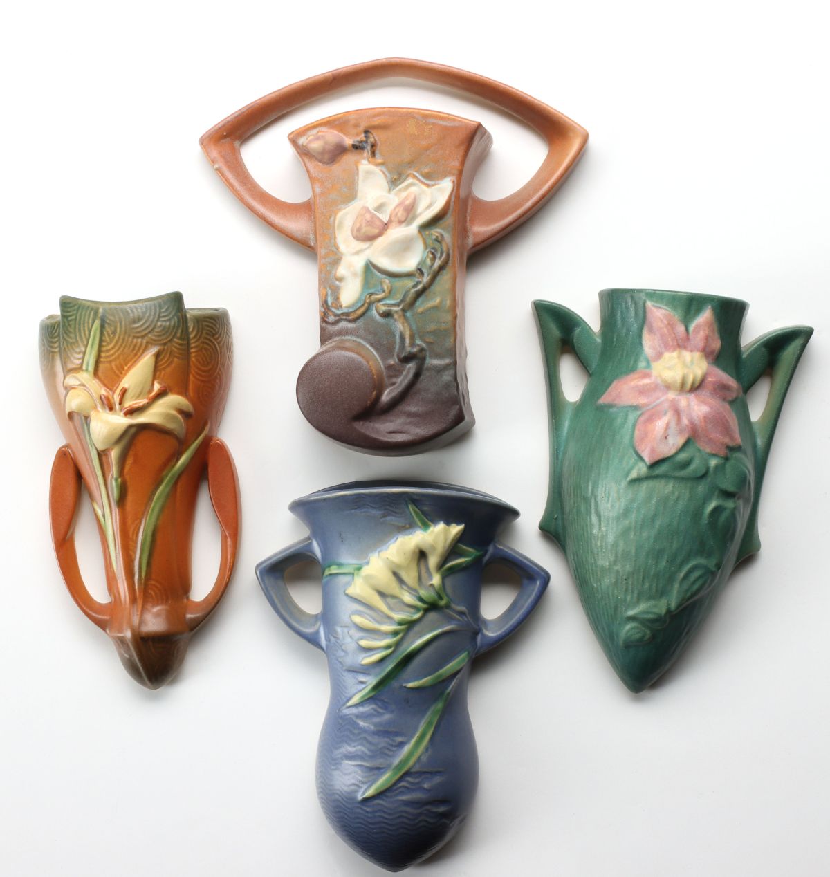 FOUR ROSEVILLE ART POTTERY FLORAL PATTERN WALL POCKETS