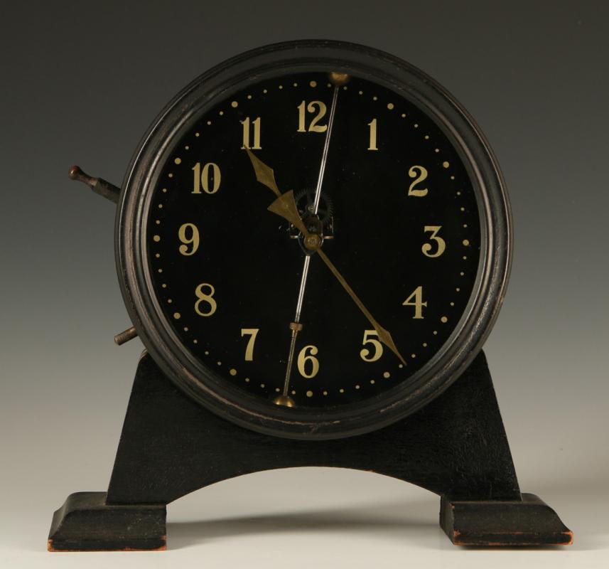 AN EARLY 20TH CENTURY GRAVITY FEED CLOCK