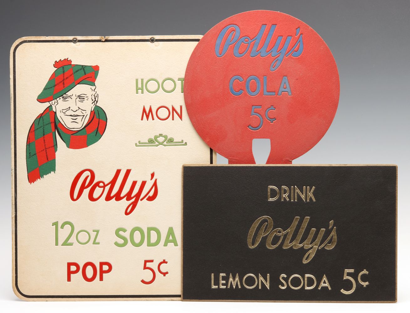 A COLLECTION OF POLLY'S SODA POP ADVERTISING SIGNS