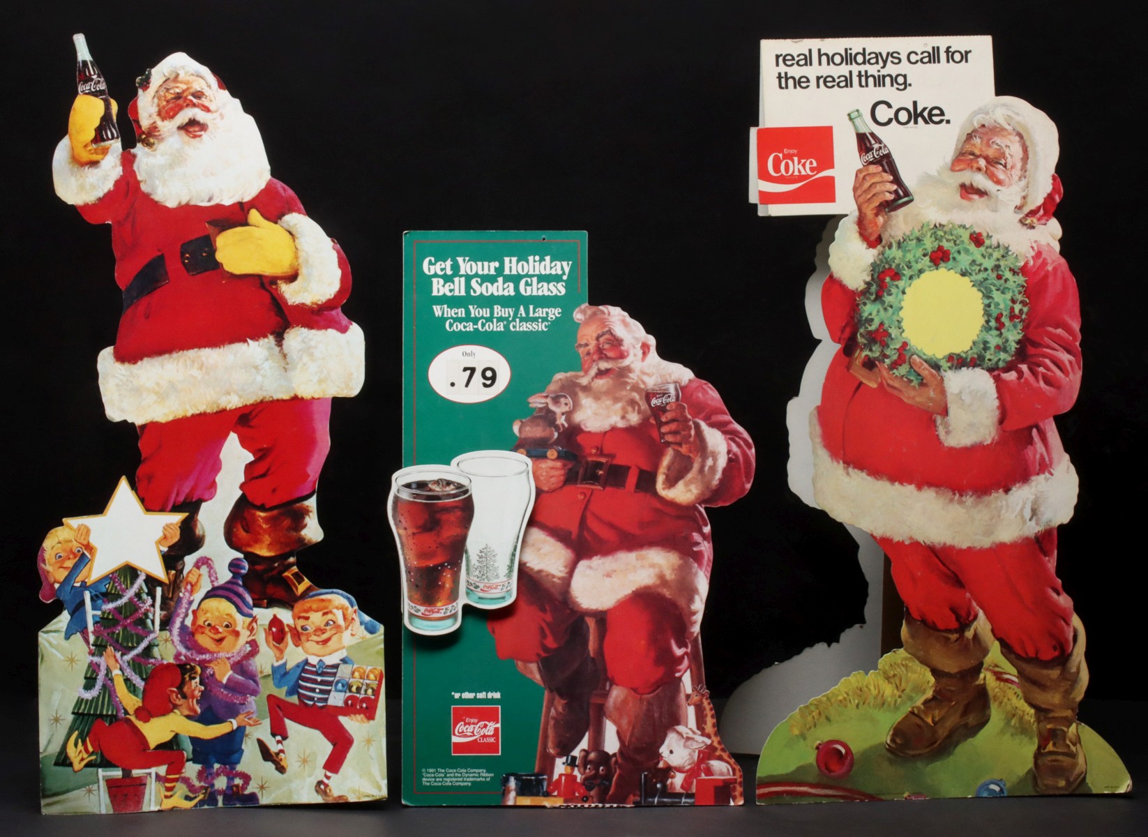 A COLLECTION OF COCA-COLA ADVERTSING DISPLAYS WITH SANTA
