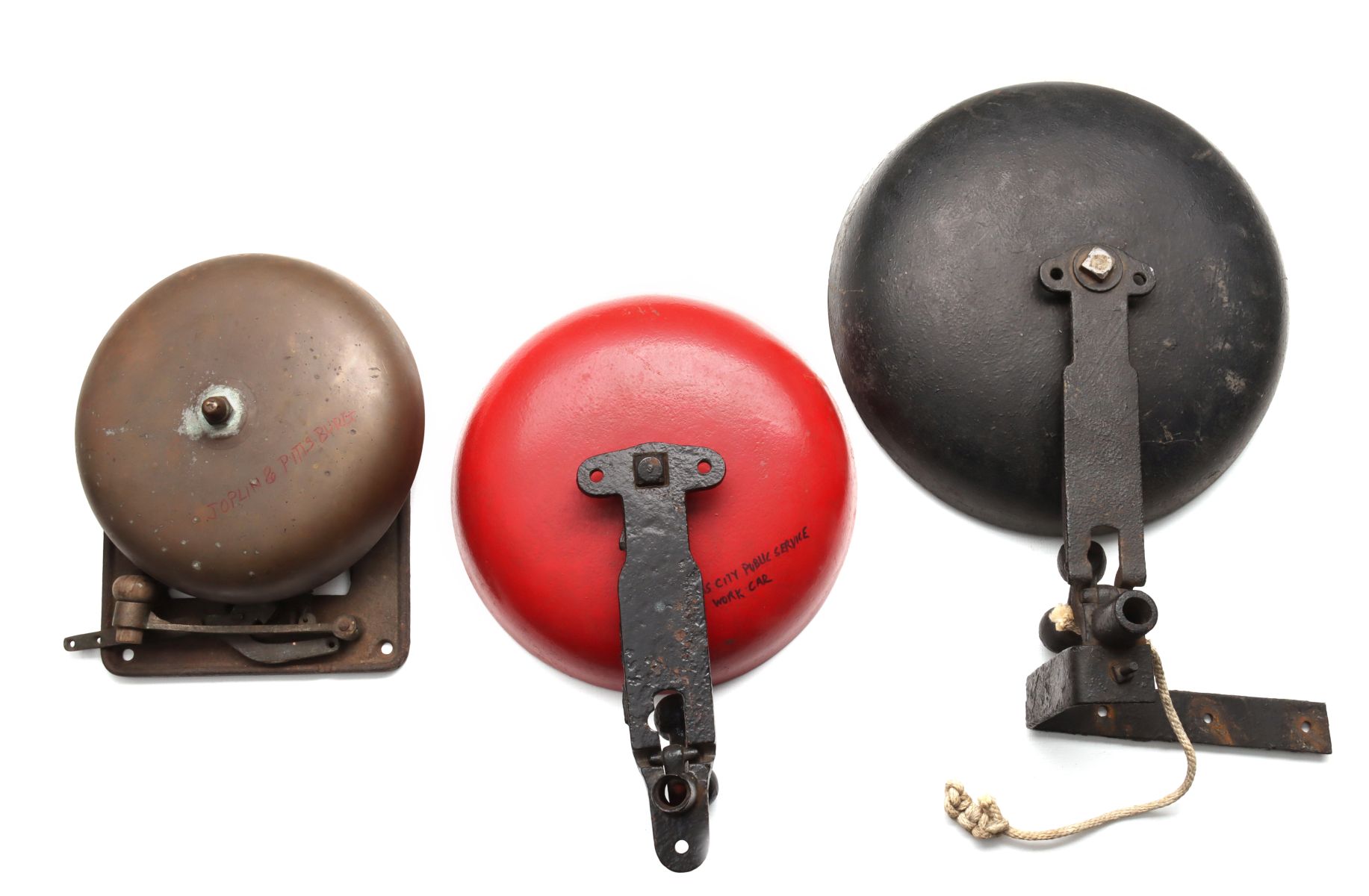 THREE ANTIQUE CAST IRON AND BRASS TROLLEY BELLS