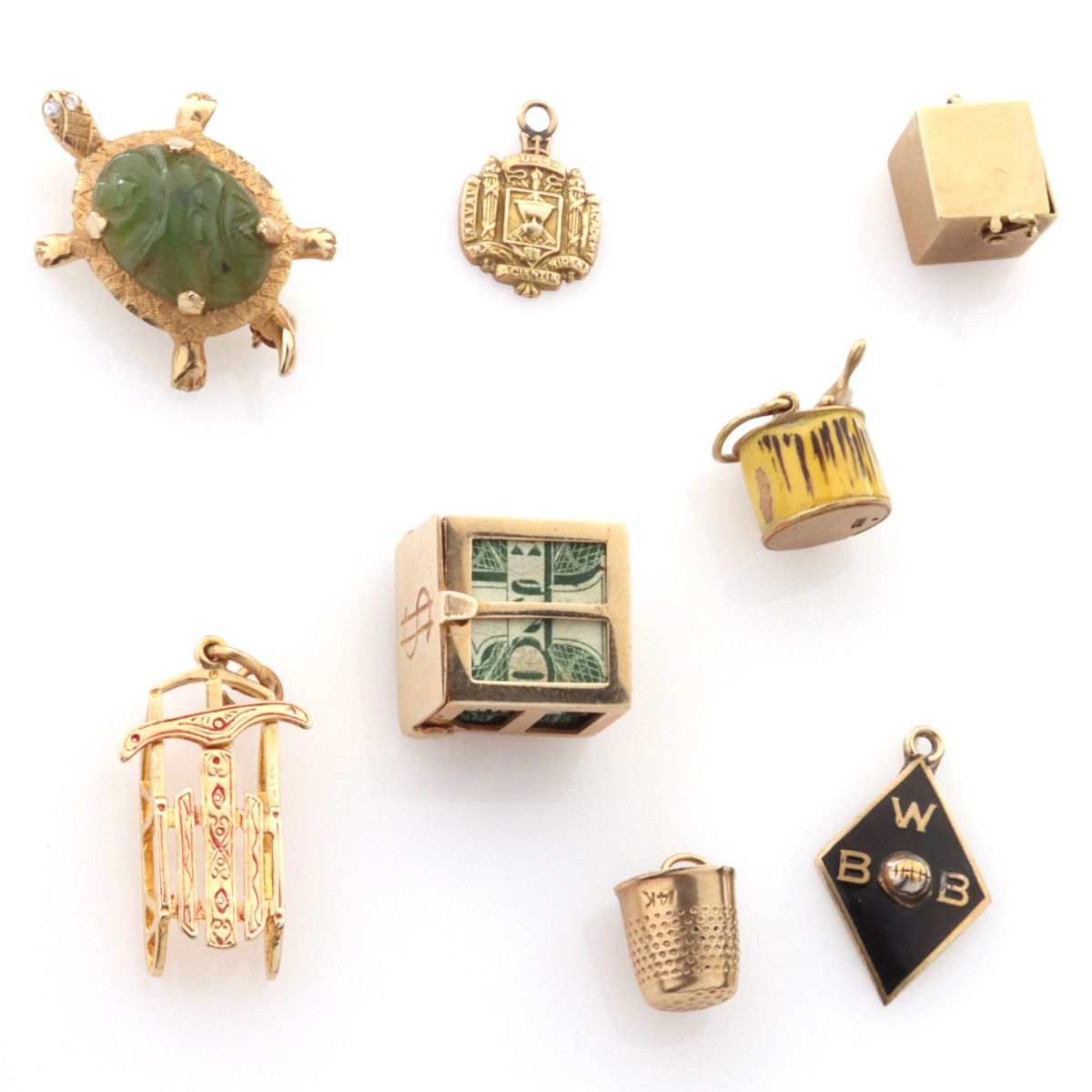 A COLLECTION OF 14K GOLD CHARMS ALONG WITH TURTLE PIN