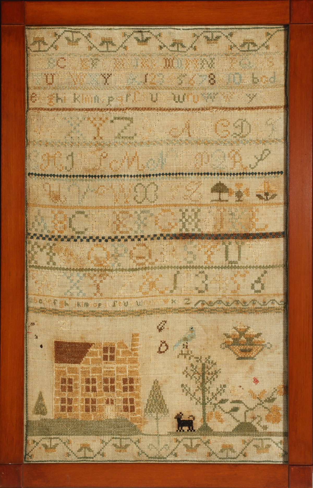 A 19TH CENTURY CROSS STITCH SAMPLER WITH HOME AND DOG