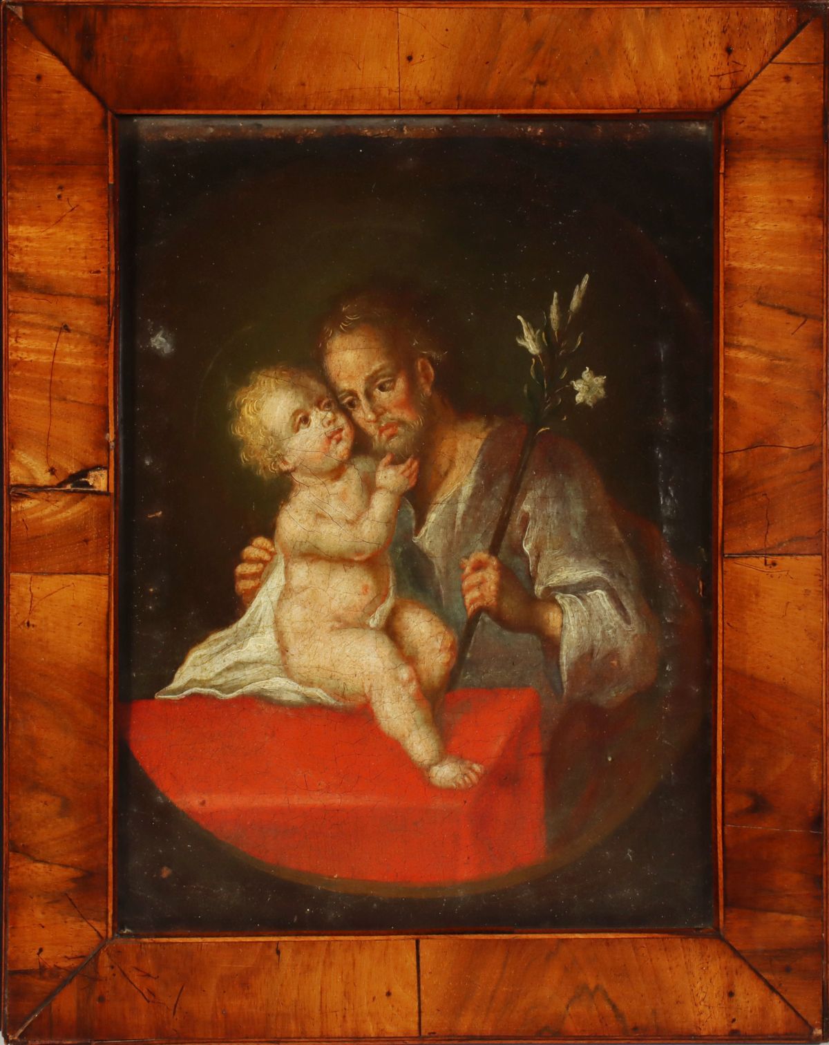 A 17TH CENTURY OIL OF ST. JOSEPH AND THE INFANT JESUS