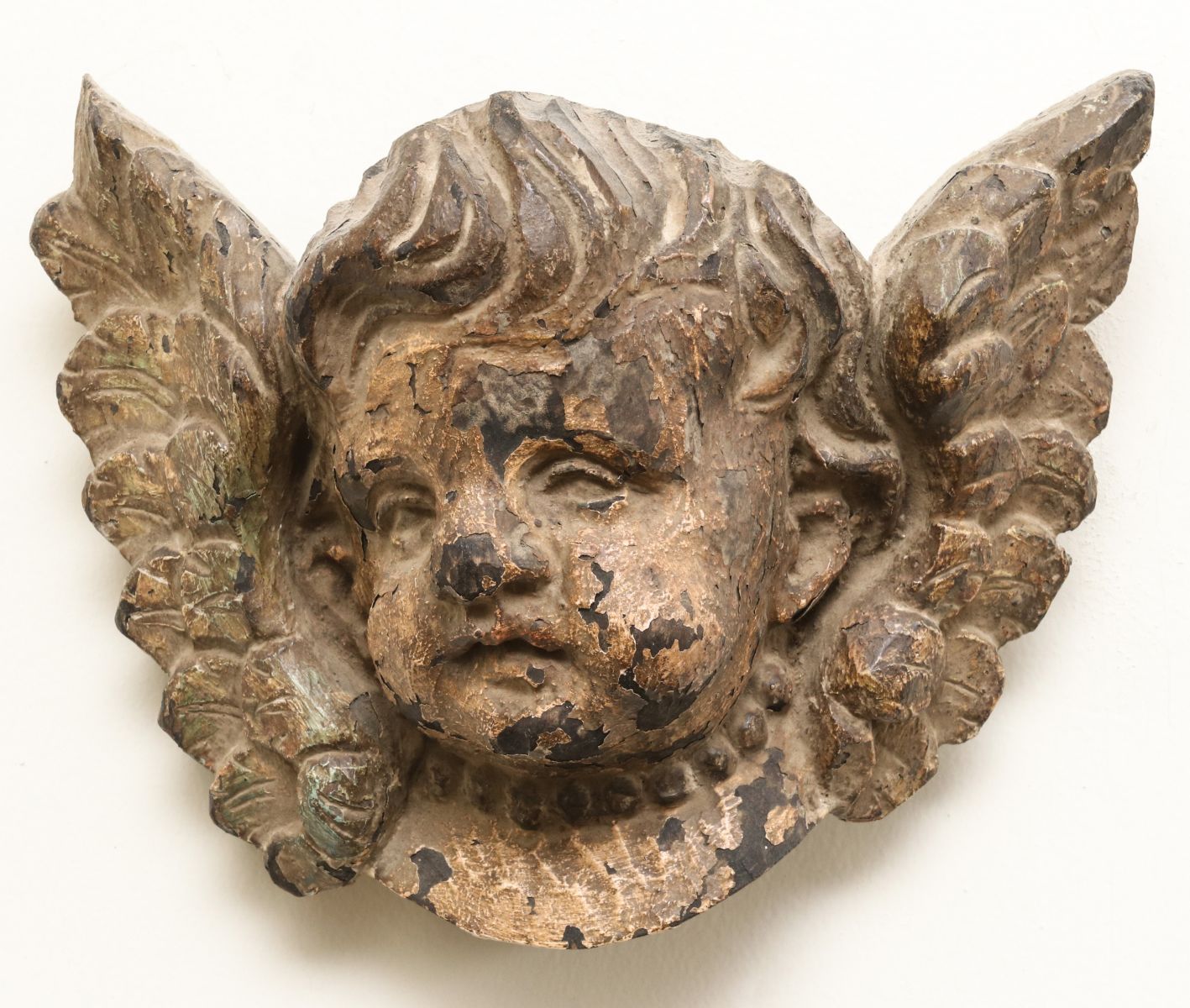 A CARVED AND PAINTED WOOD WINGED CHERUB BUST