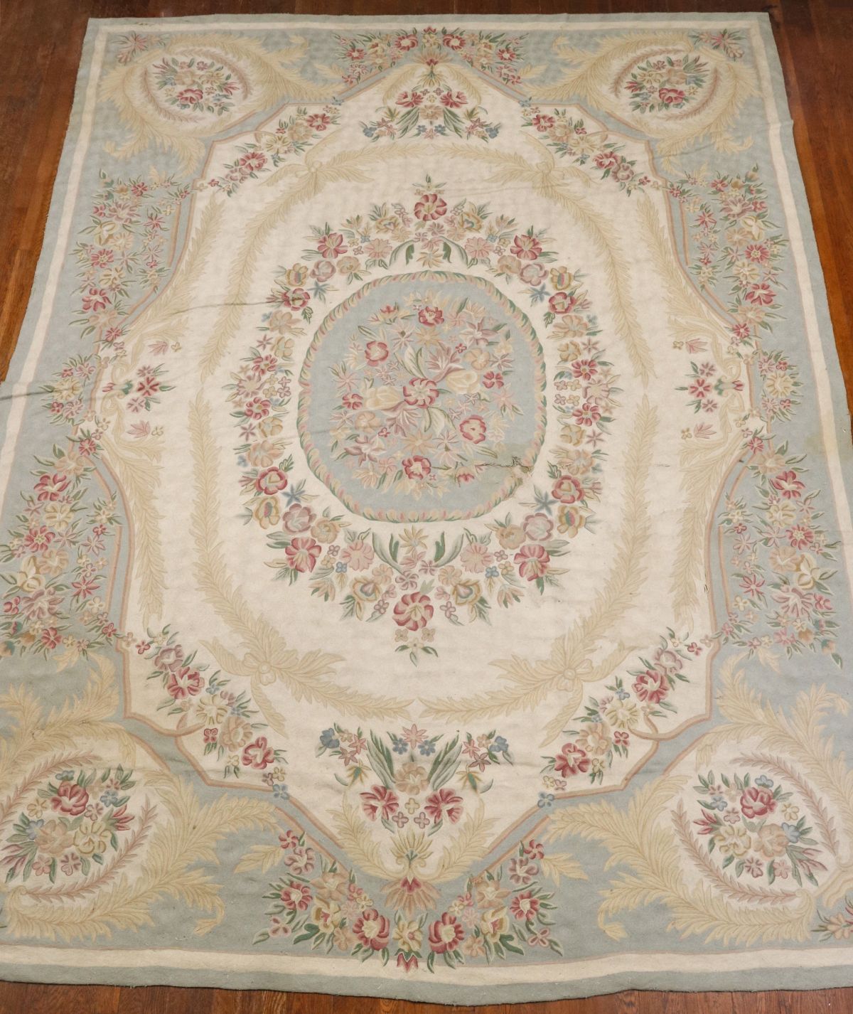 A 20TH C. FRENCH NEEDLEPOINT RUG AS FOUND