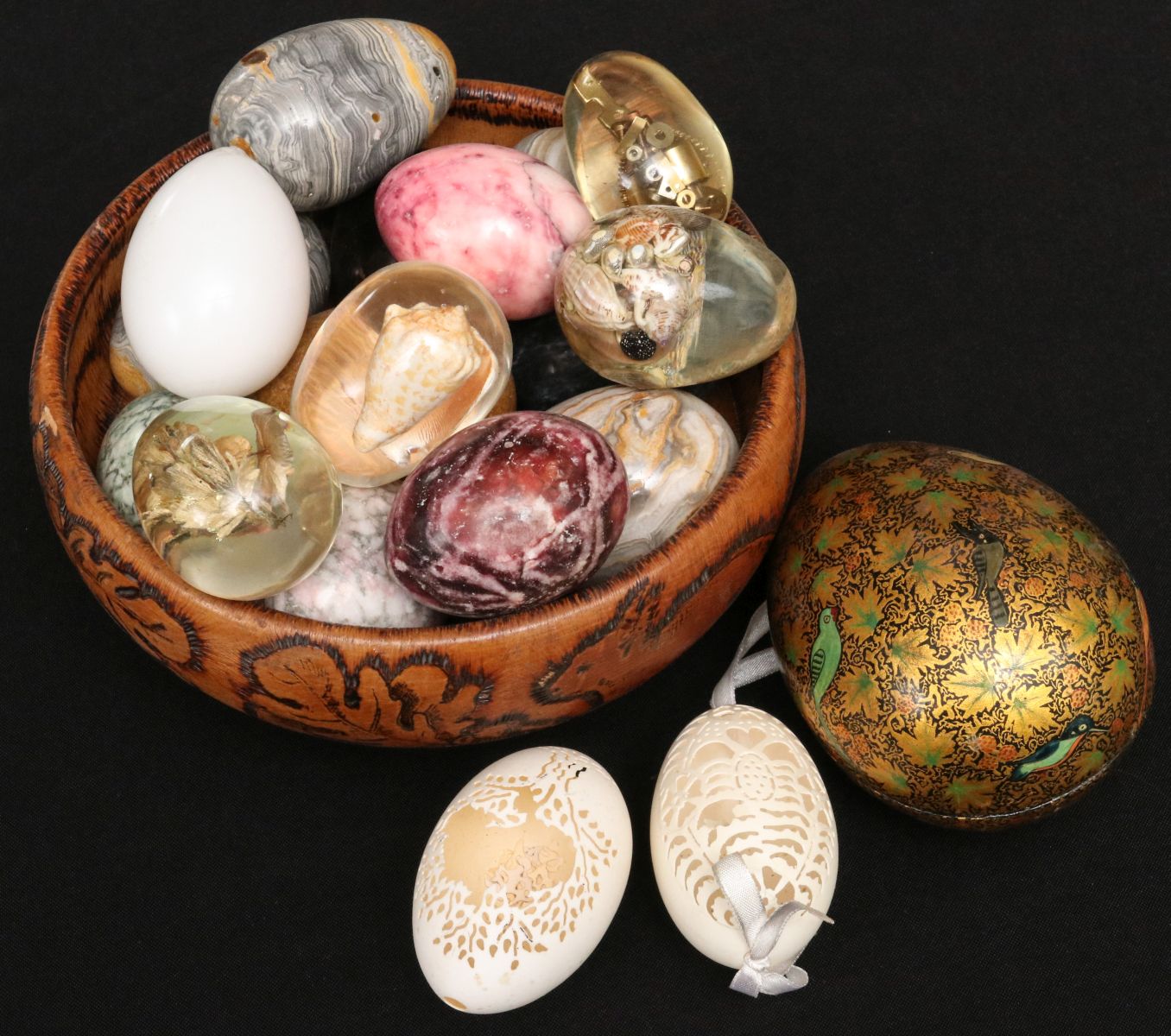 A COLLECTION OF UNUSUAL EGGS IN PYROGRAPHY BOWL