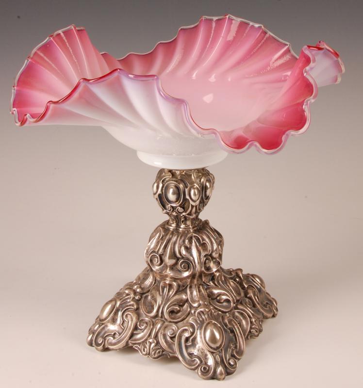 A CASED CRANBERRY GLASS BOWL ON ORNATE SILVER STAND