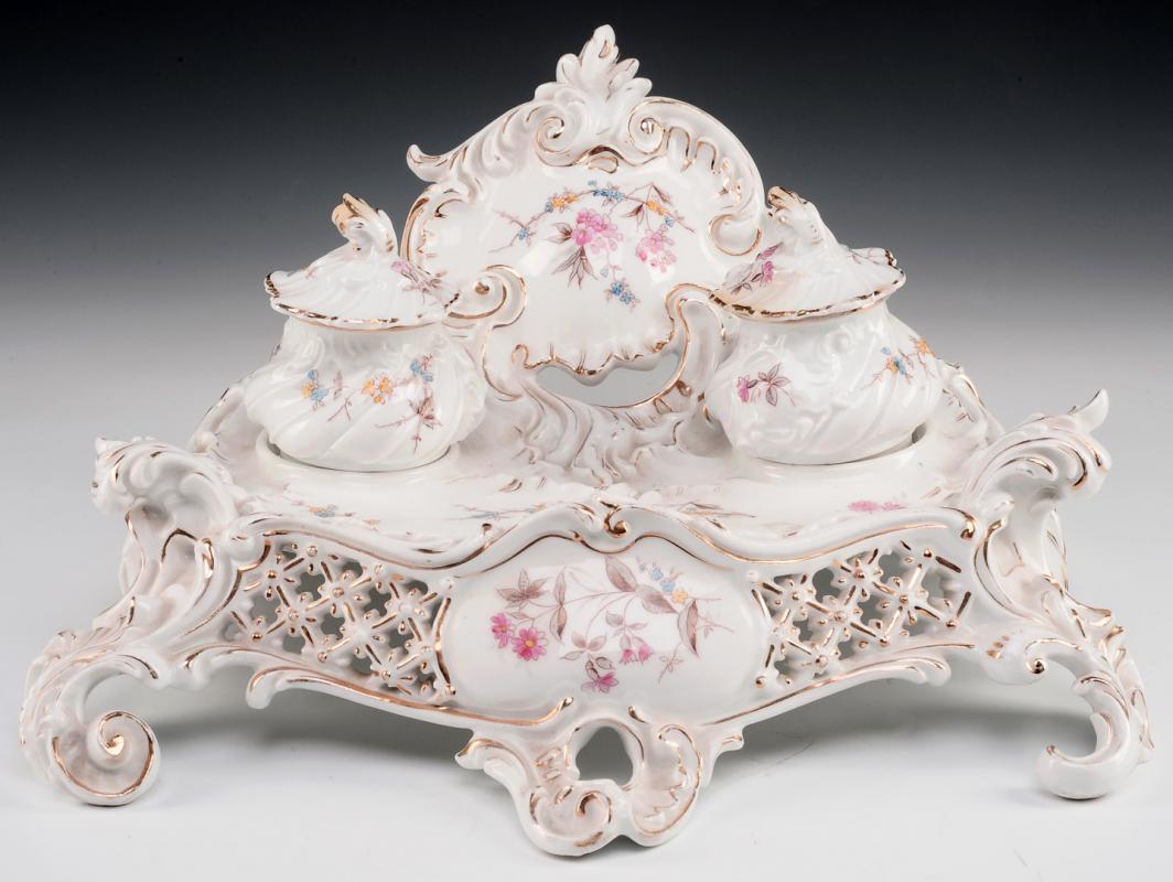 A CONTINENTAL PORCELAIN ROCOCO INK AND SANDER ON STAND