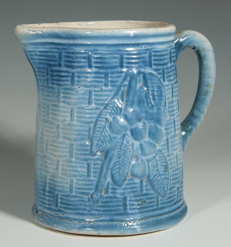 AN ANTIQUE BLUE AND WHITE PITCHER WITH CHERRIES