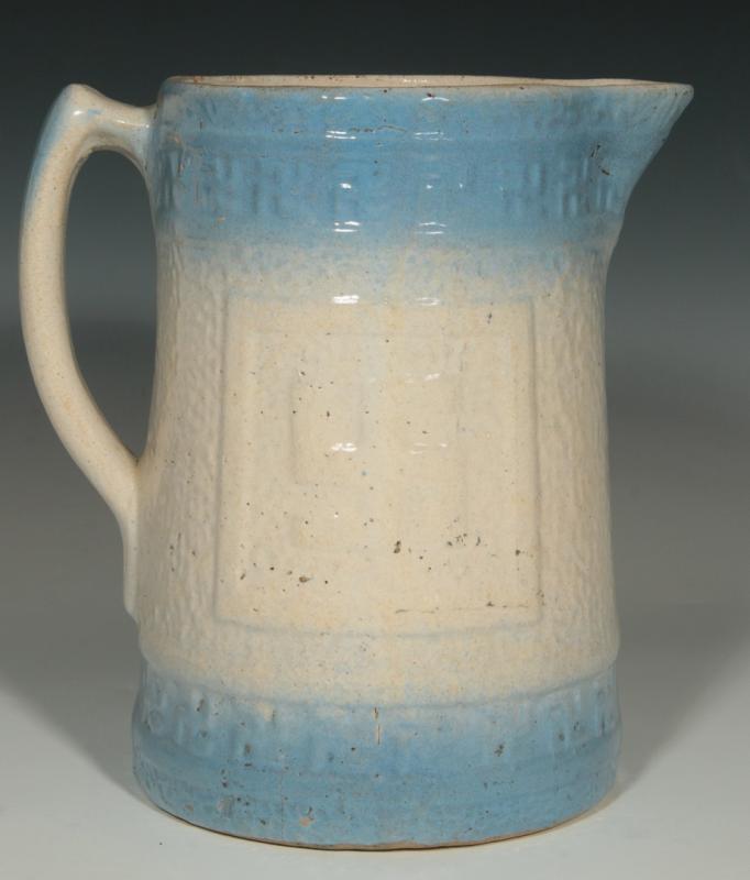 AN ANTIQUE BLUE AND WHITE STONEWARE PITCHER 