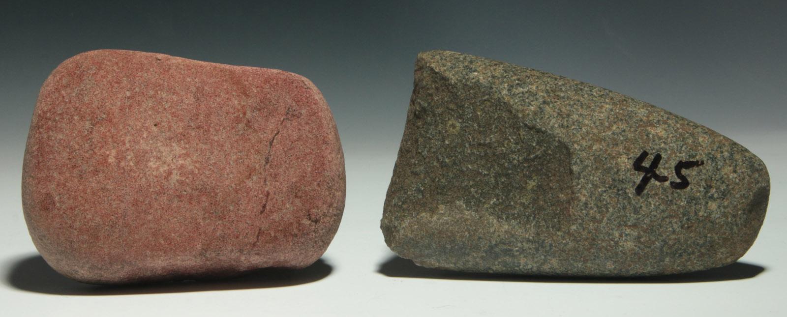 A 6.5-INCH MANO GRINDING STONE AND BROKEN CELT