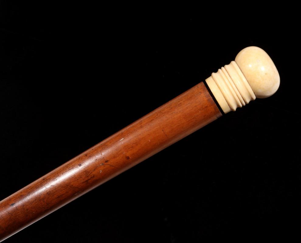 A 19TH C. CHERRY WOOD AND IVORY WALKING STICK 