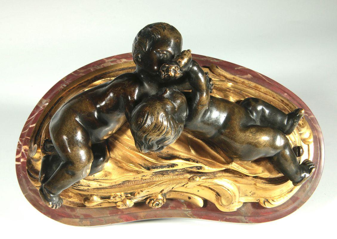 A GILT AND PATINATED BRONZE PUTTI GROUP