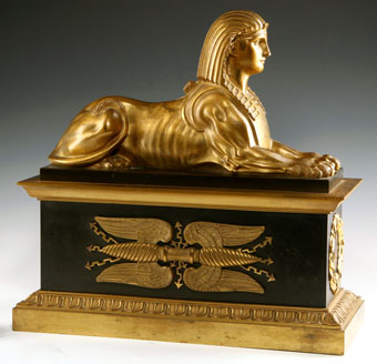 pair of gilt and paginated bronze chenets with sphinx